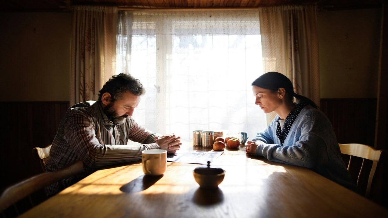A couple looking sad at the dining table