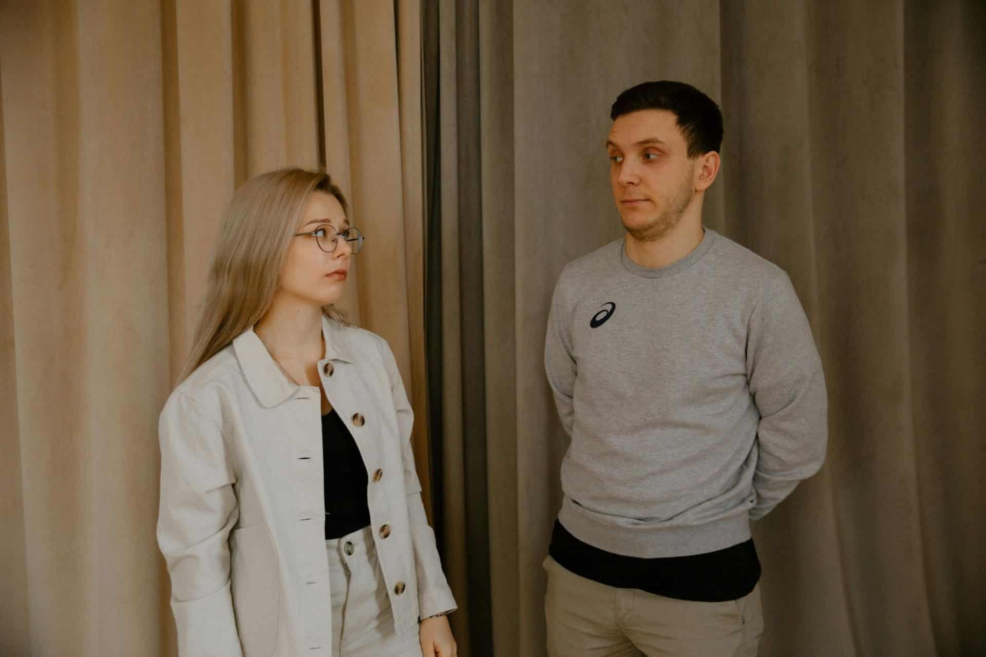 A man and woman looking awkward