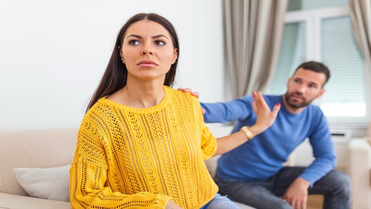 A couple arguing in the living room