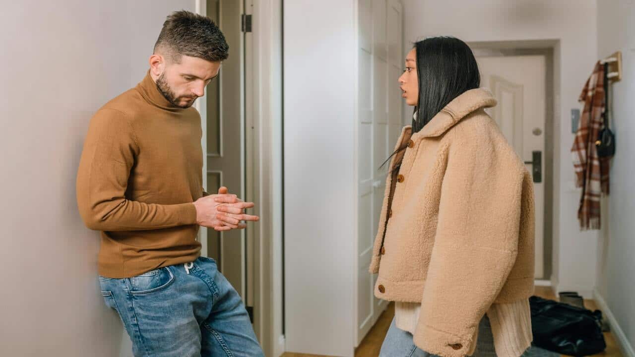 A couple arguing by the entryway