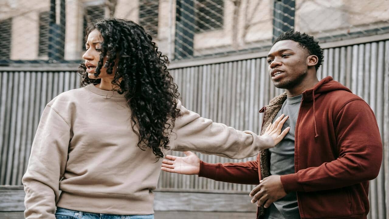 A couple arguing outdoors