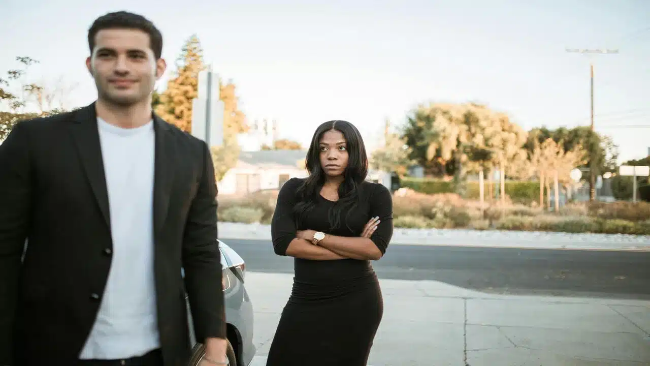 A woman looking upset at her boyfriend