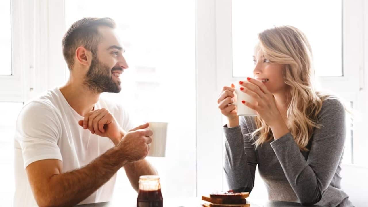 Couple smiling while exchanging stories at a restaurant