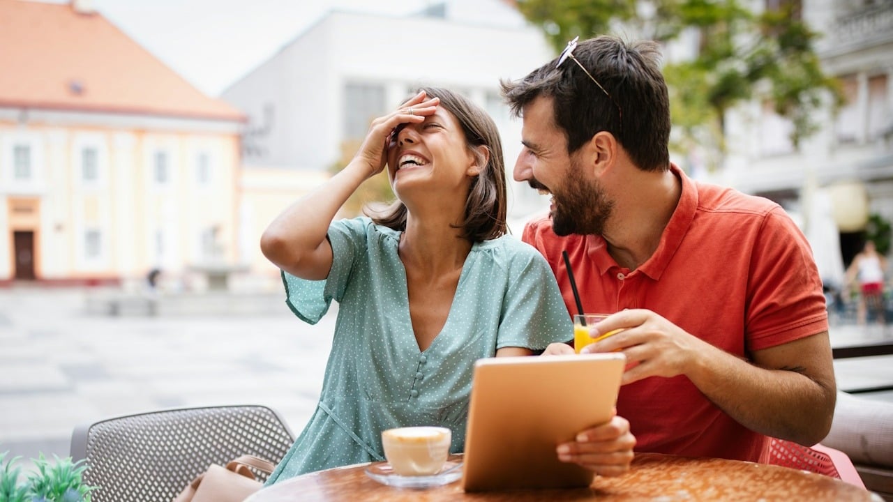 A beautiful couple having fun on a date in a cafe.