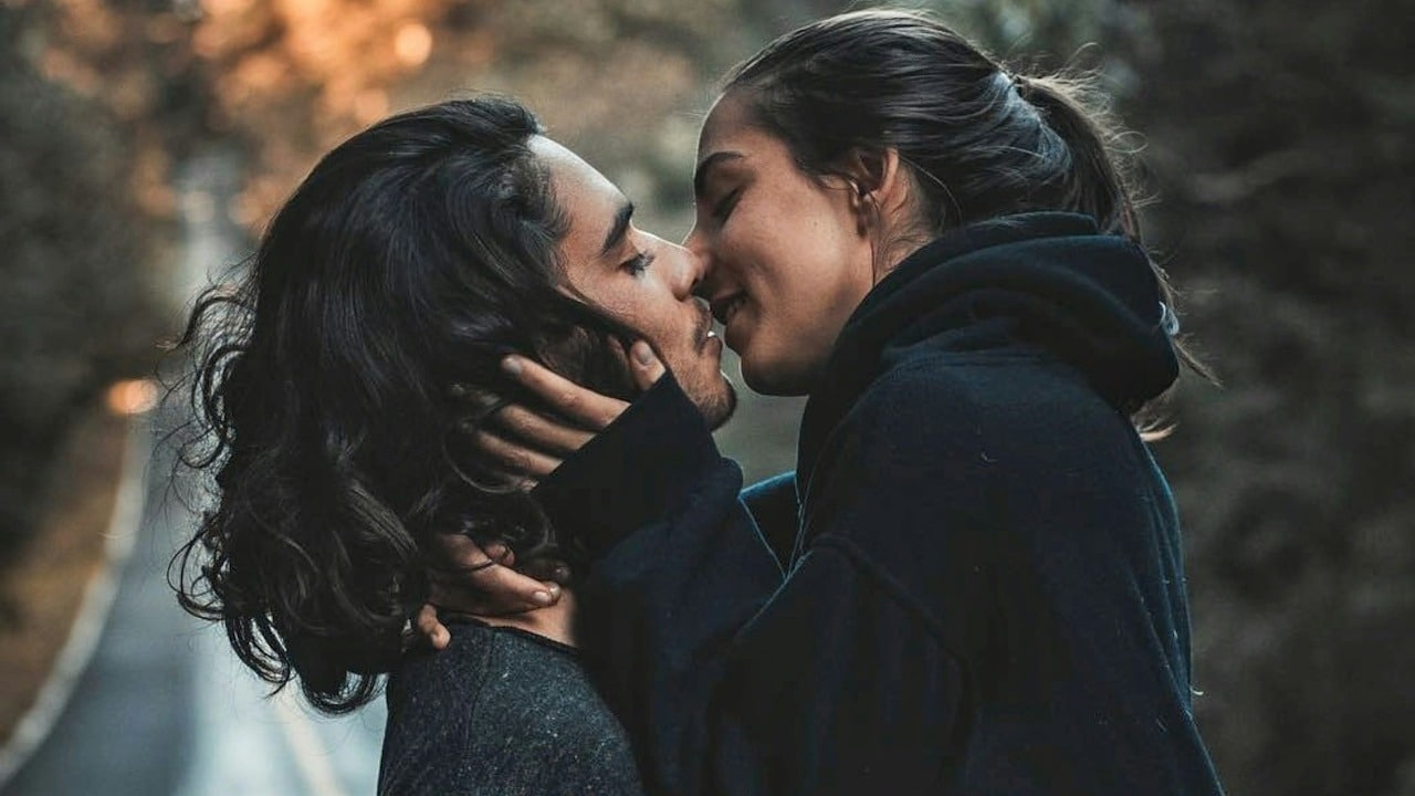 A man and a woman kissing each other.