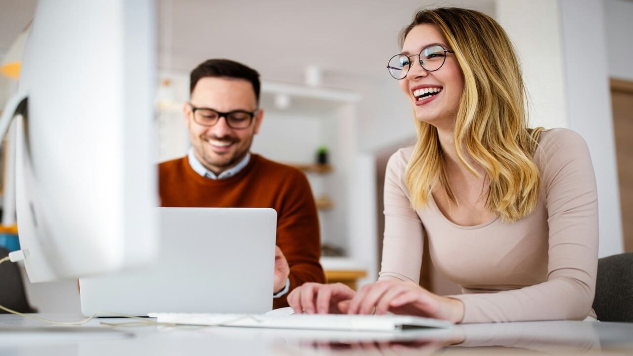 A couple laughing at work