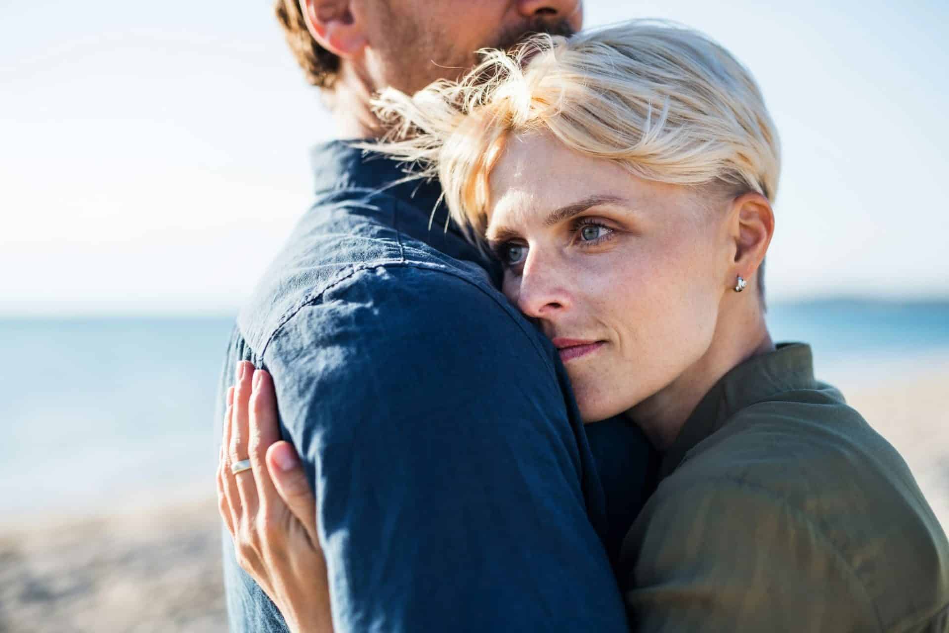A woman hugging a man tightly