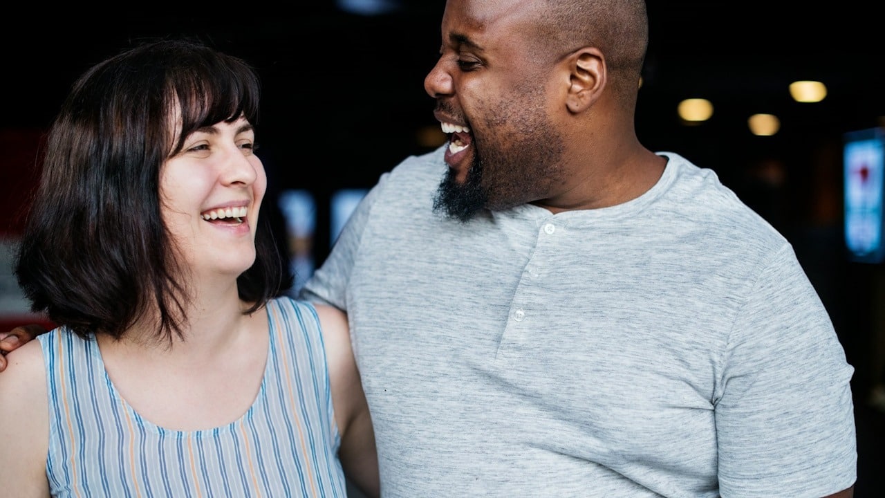 A couple laughing together.