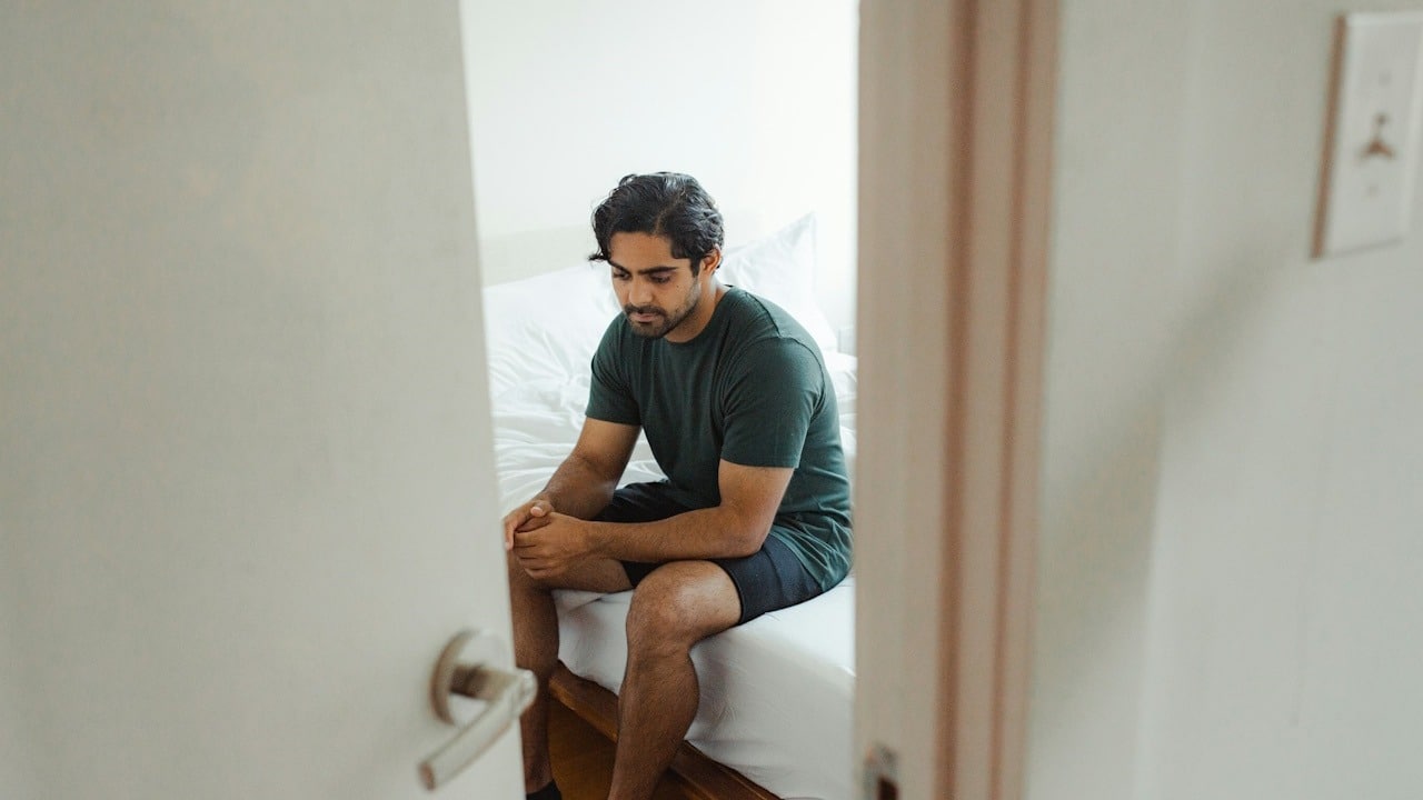 A man sitting on the bed.