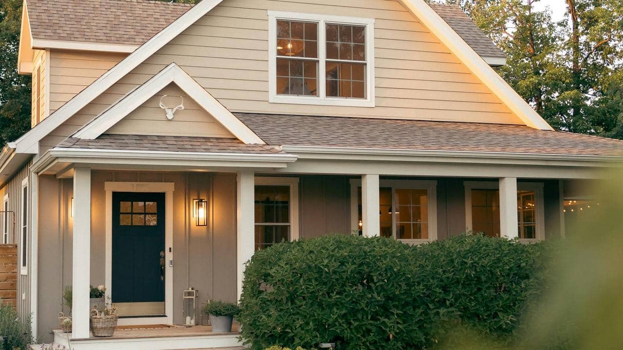 A cozy house with a front porch and warm lights.