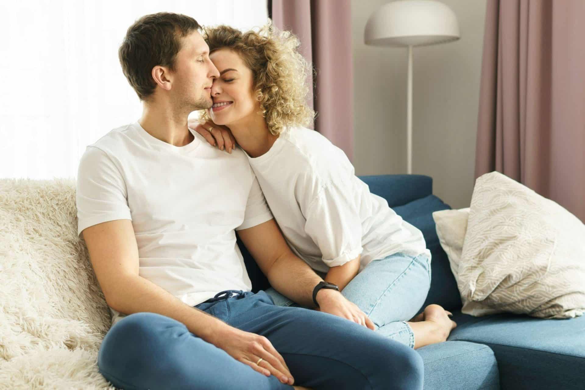 A man kissing a woman’s head