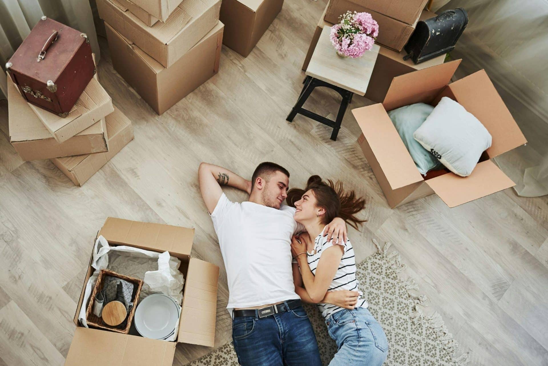 A man and woman talking while lying on the floor