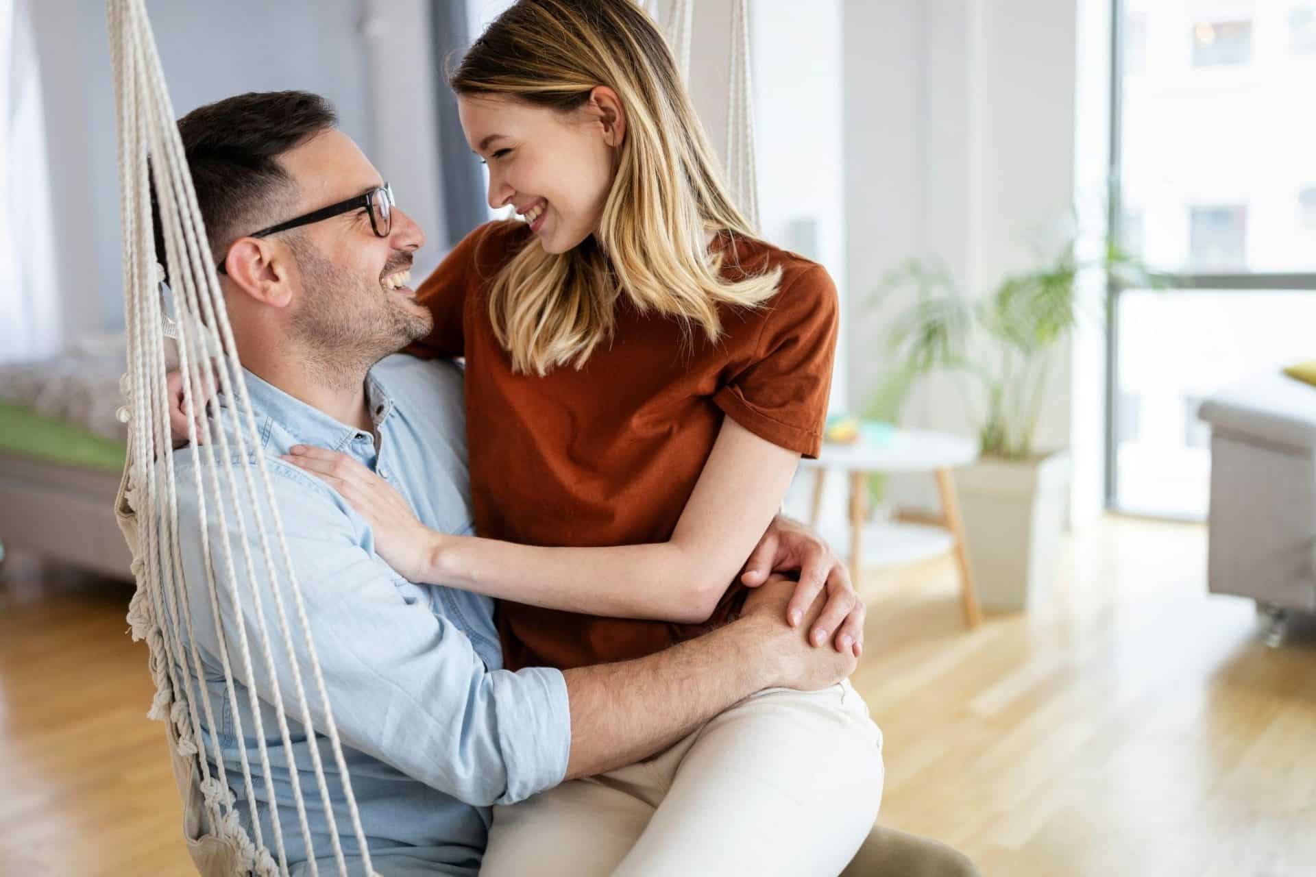 A woman sitting in a man’s lap.