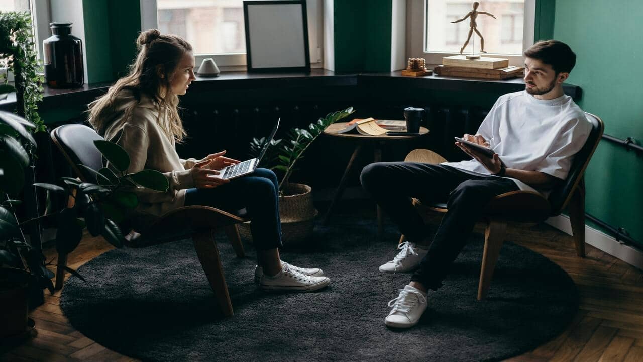 A couple talking while working