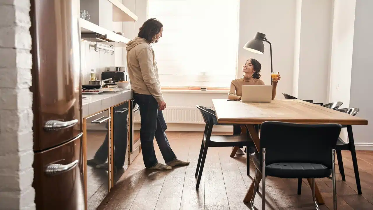 A couple talking in the kitchen