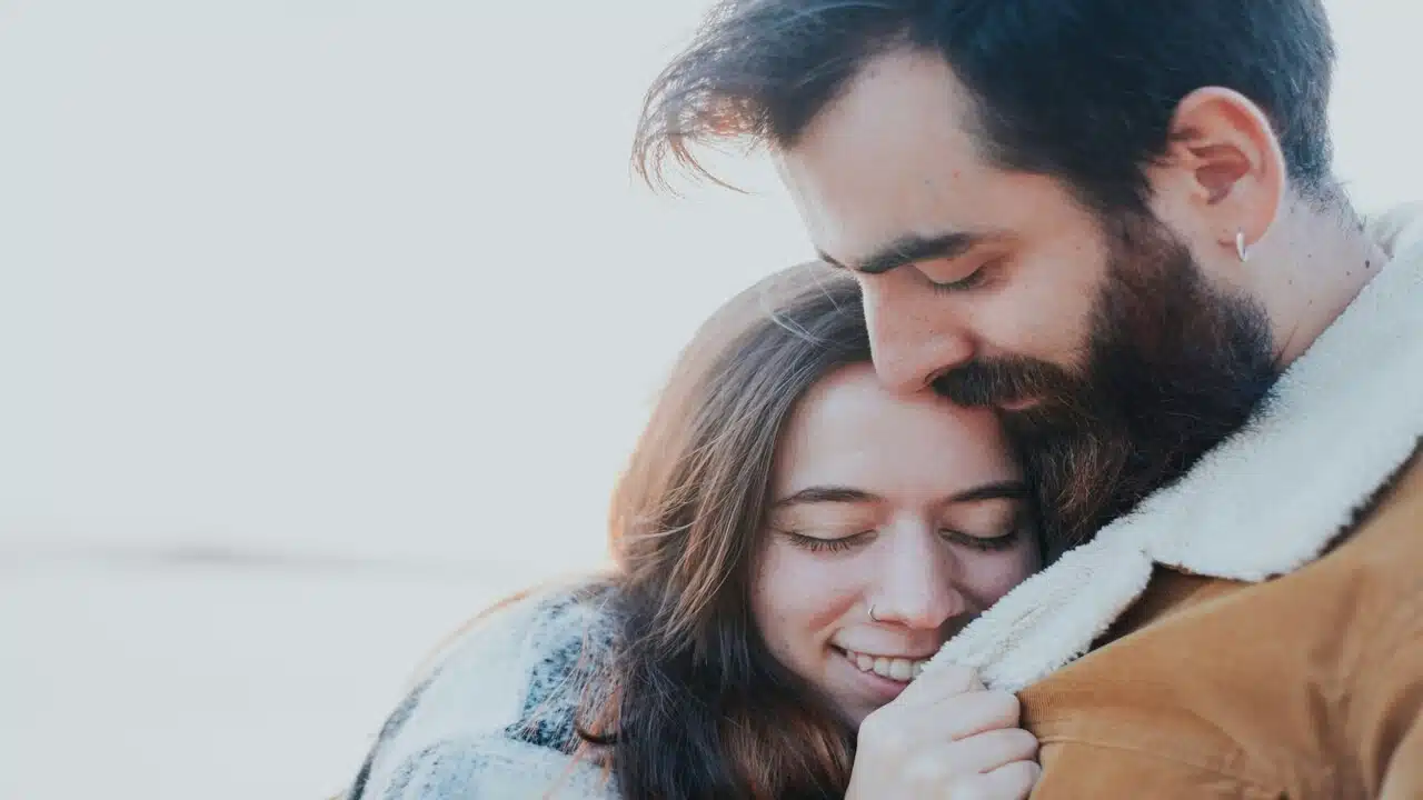 A couple hugging outdoors