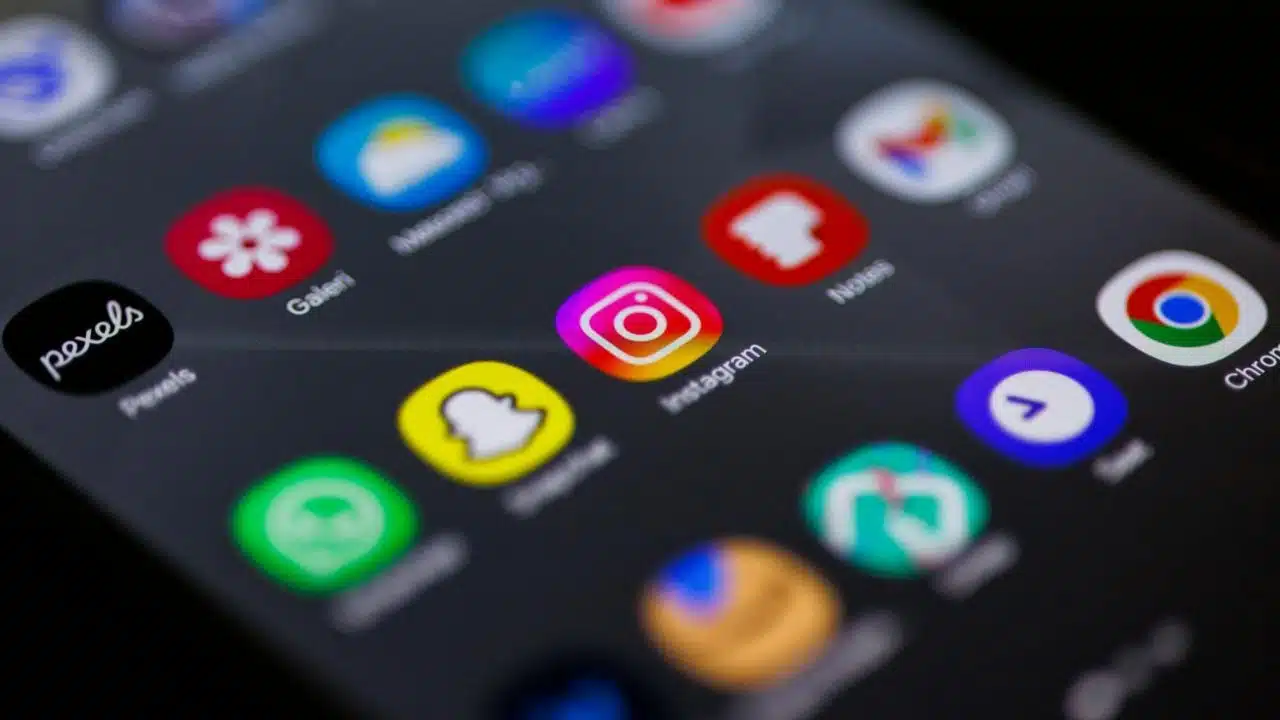 Close-up of a smartphone screen displaying various colorful social media and utility app icons.