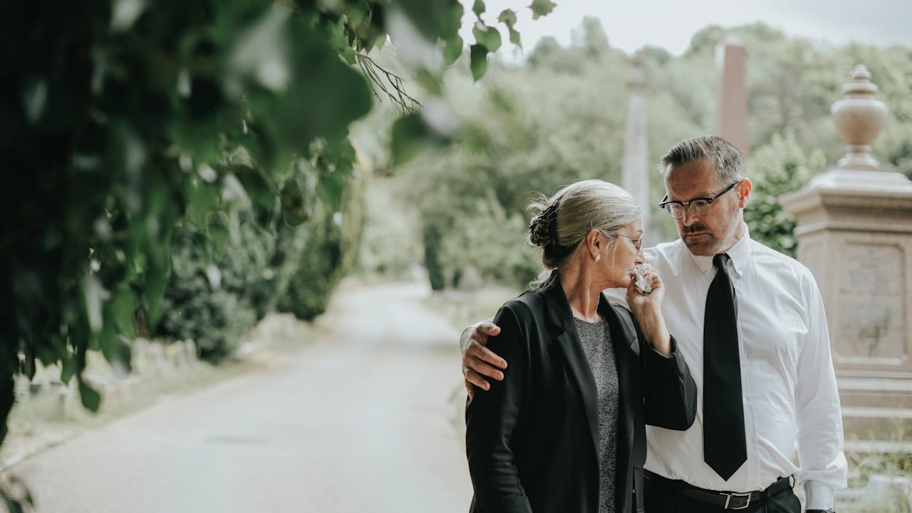 Husband trying to comfort his wife due to her loss.