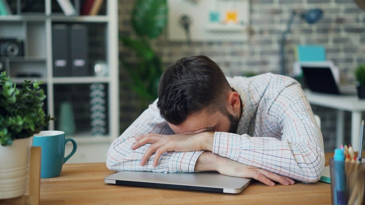 A man looking stressed at work