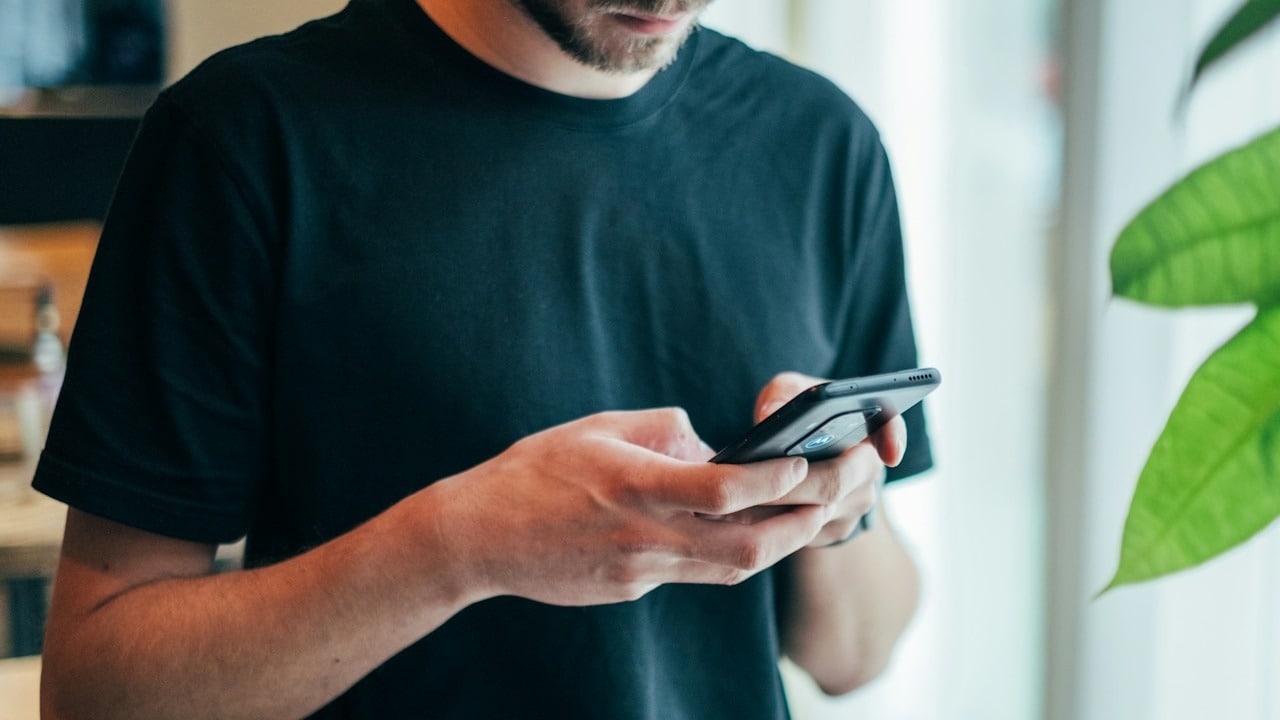 A man texting on his phone.