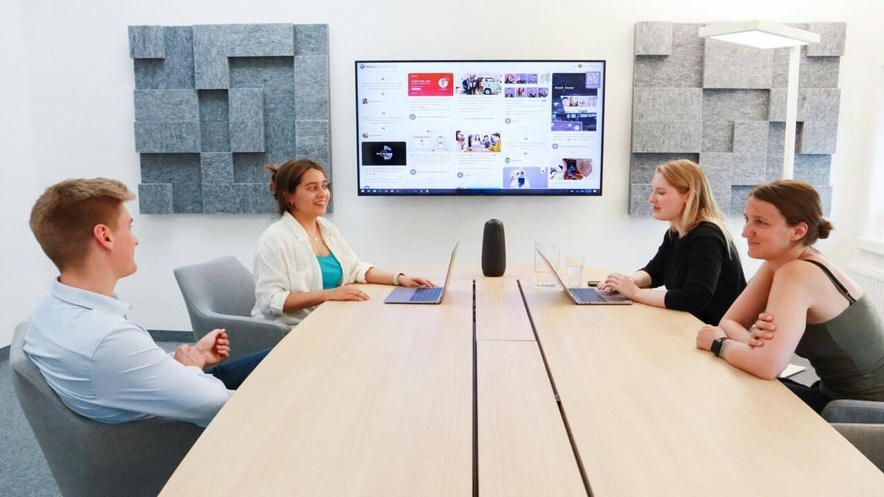 Colleagues speaking at a conference table