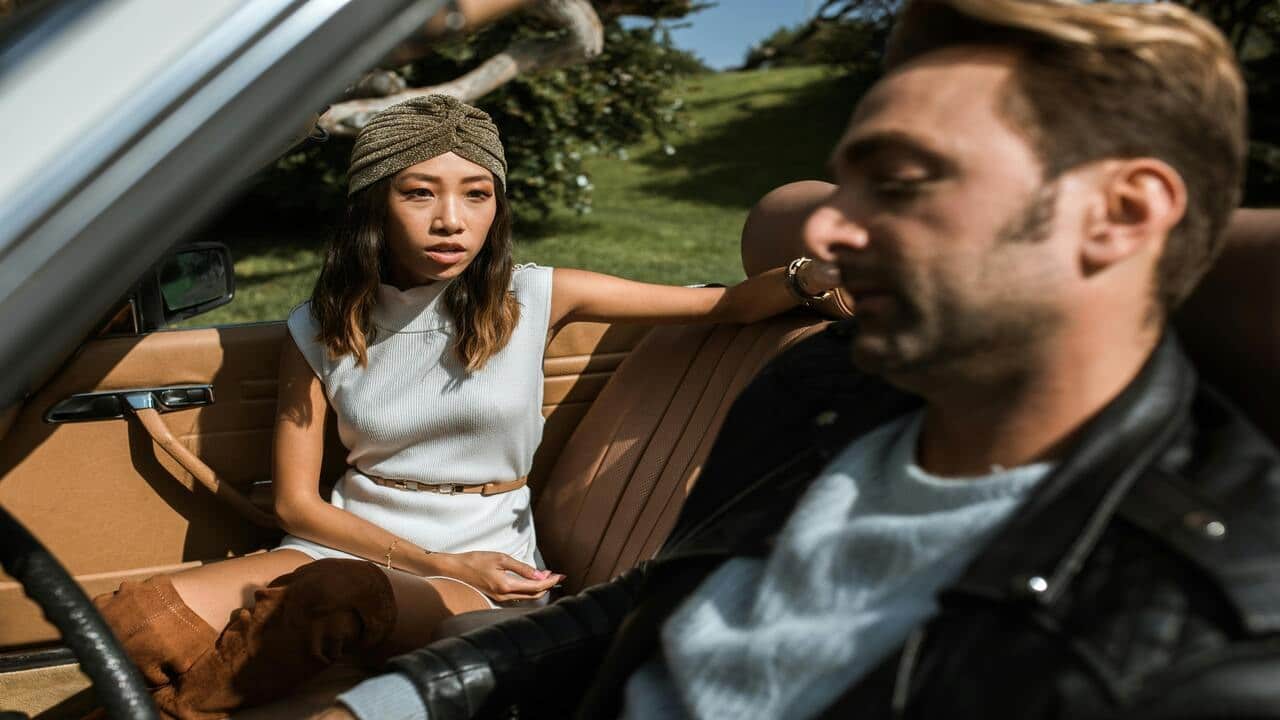 A man and a woman having a fight in the car