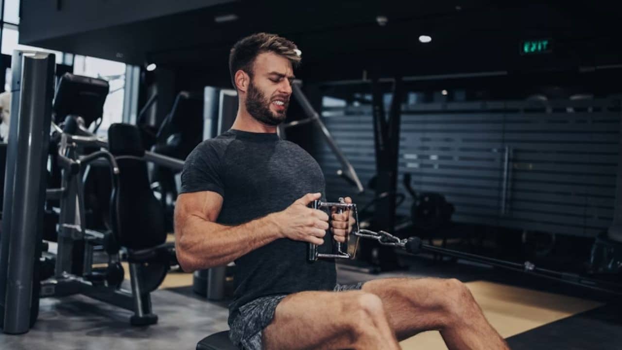 Man in the gym working his muscles out