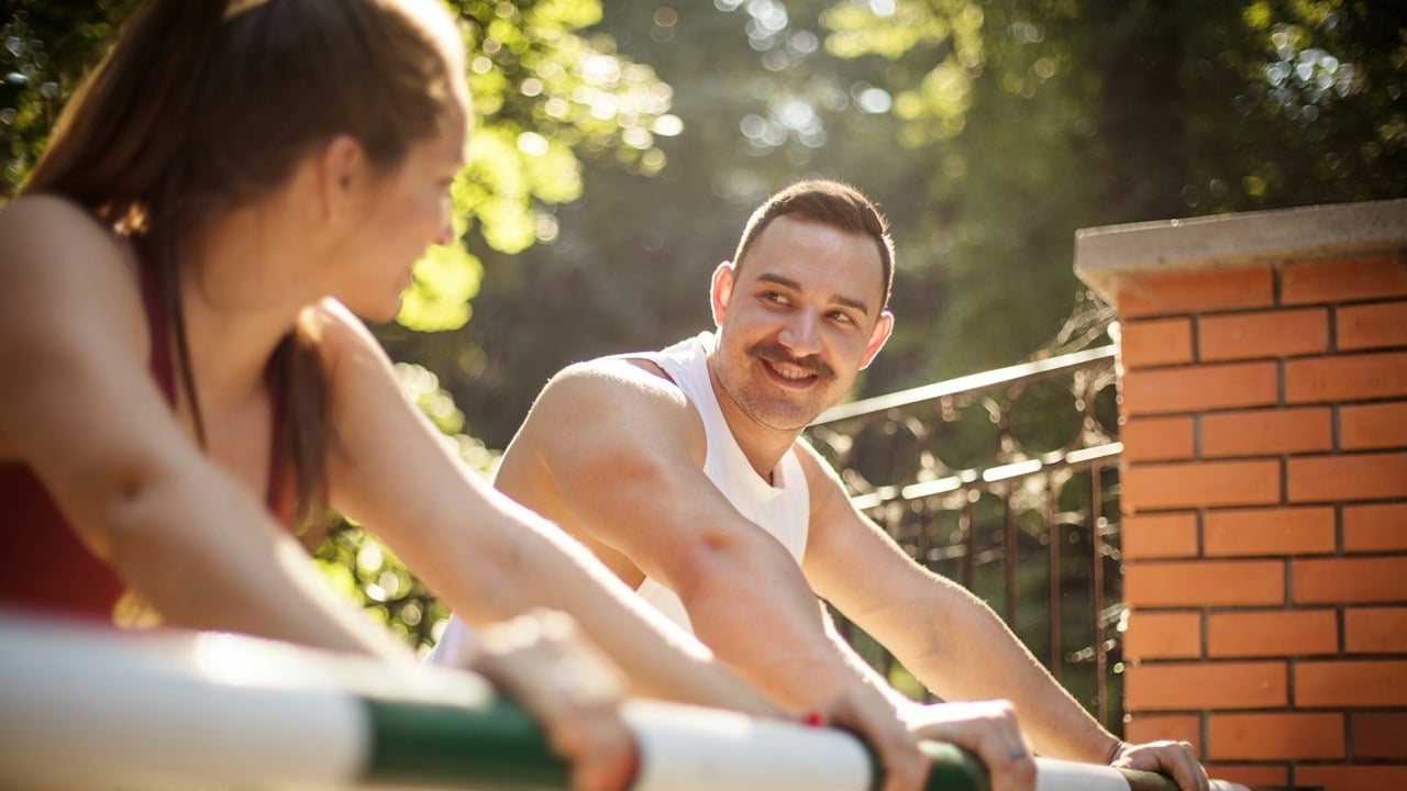 A young sporty couple working out in the park.