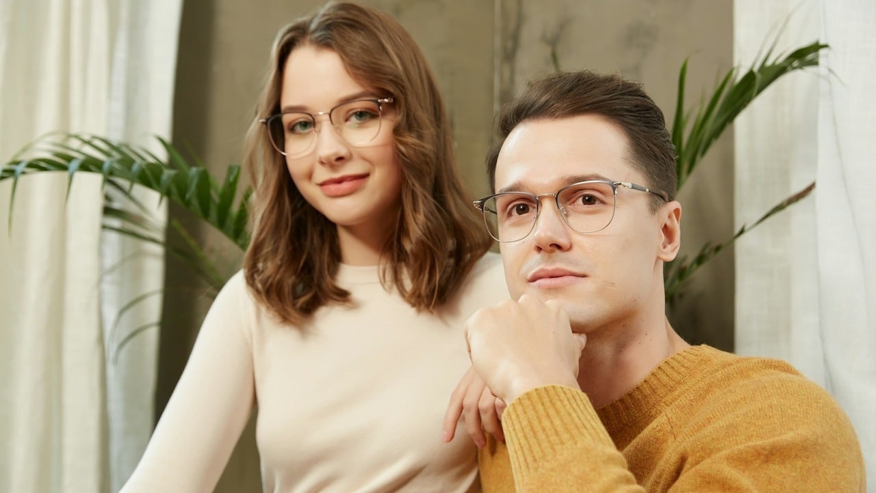 A man and a woman sitting next to each other.