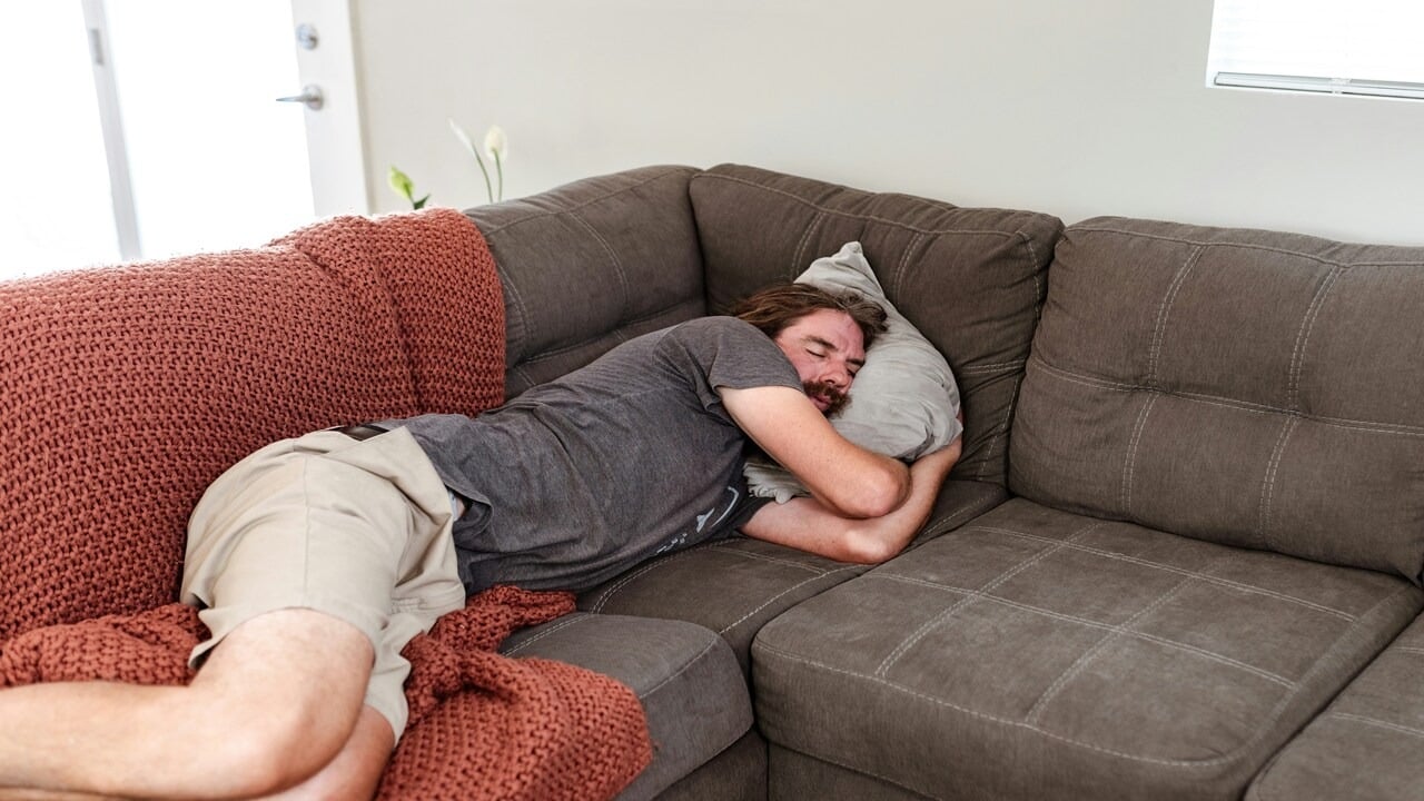 A man sleeping on the couch