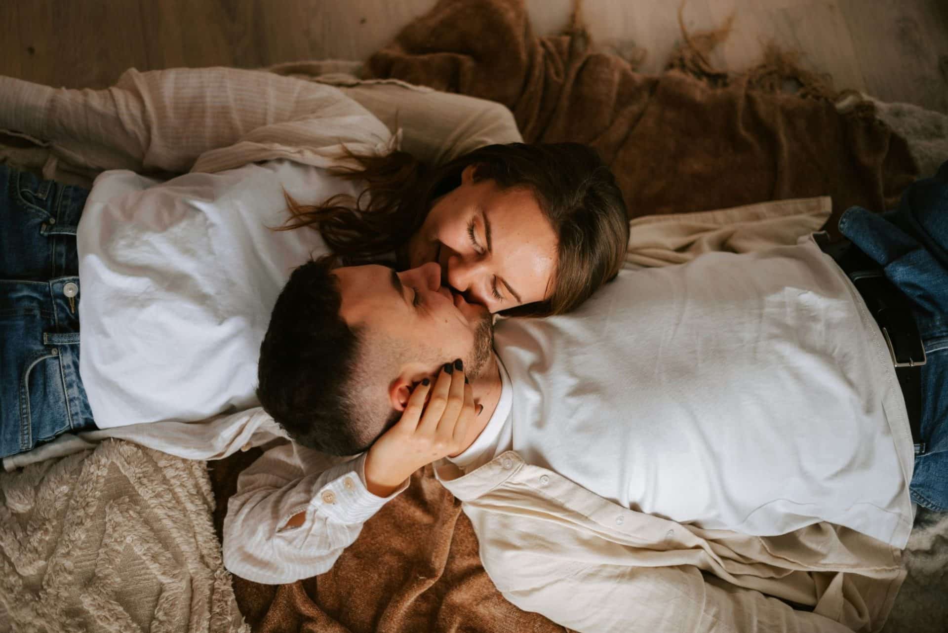 A man and woman laying on a bed