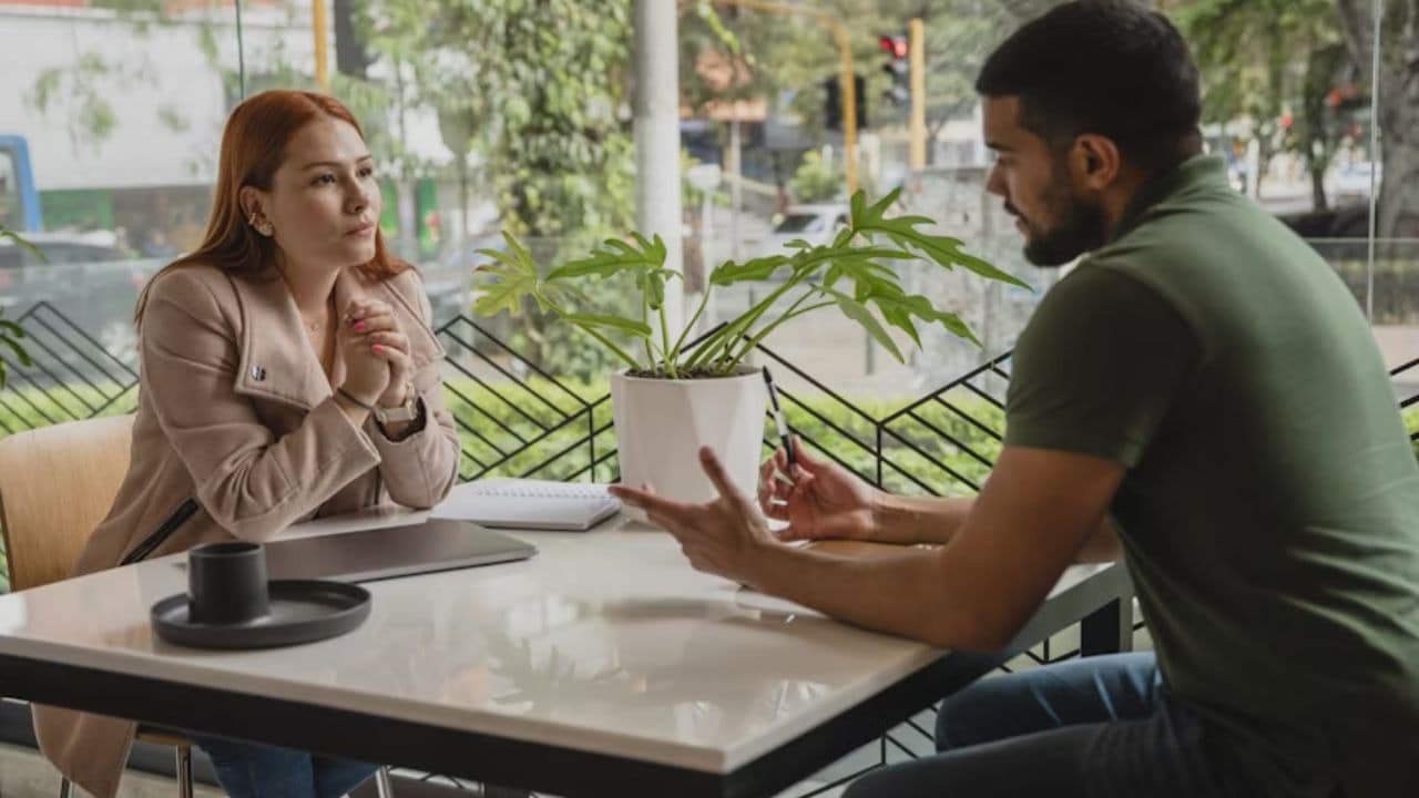 Man and woman sitting opposite each other having a serious talk