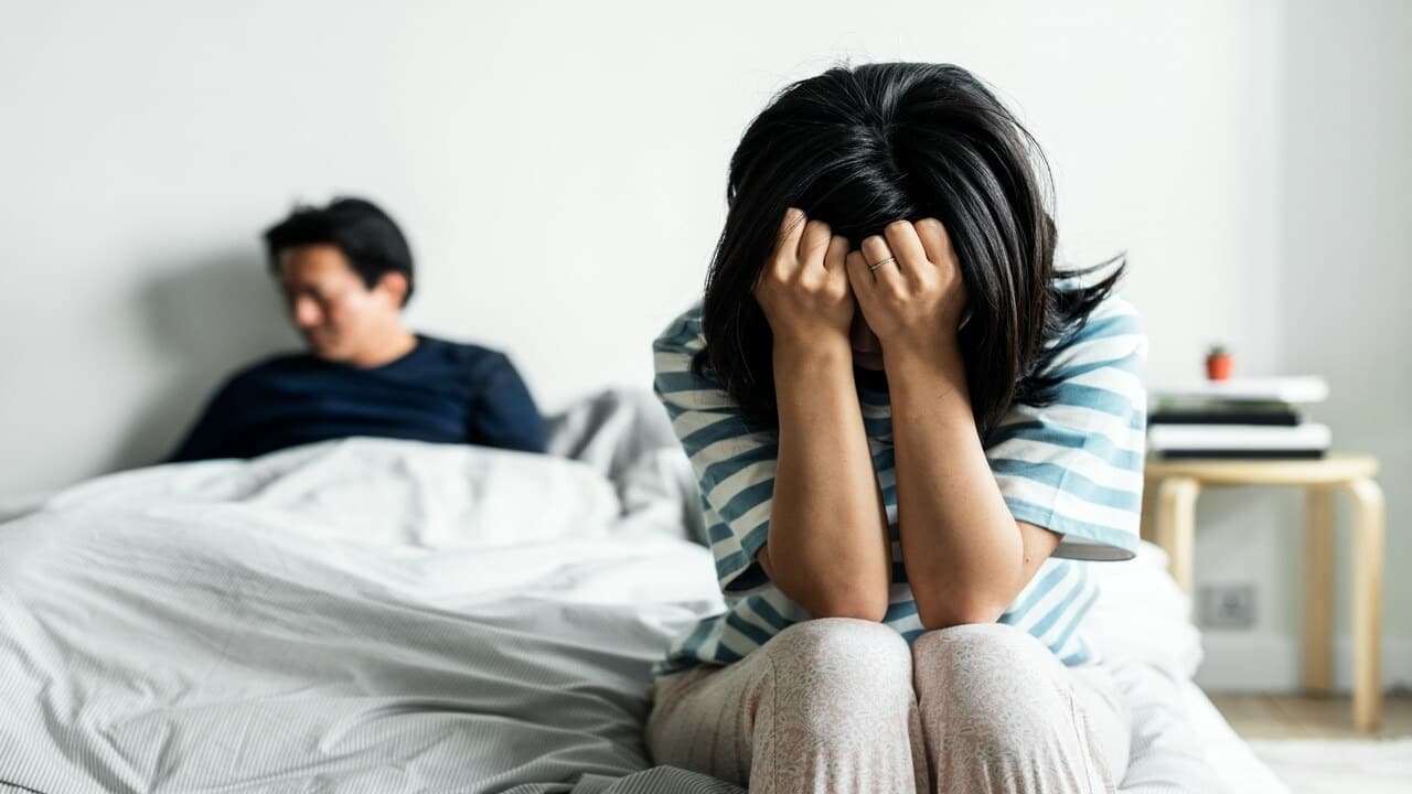 A woman looking sad in the bedroom