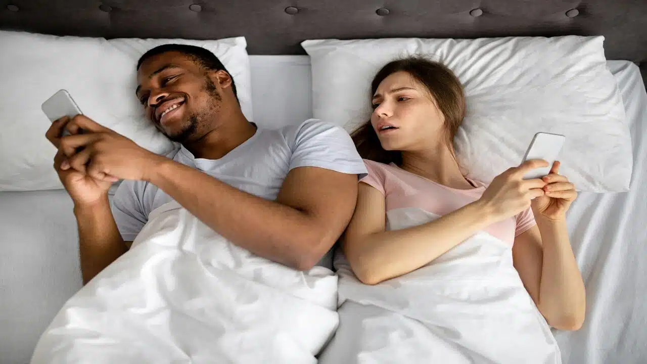 A woman looking at who her husband is texting