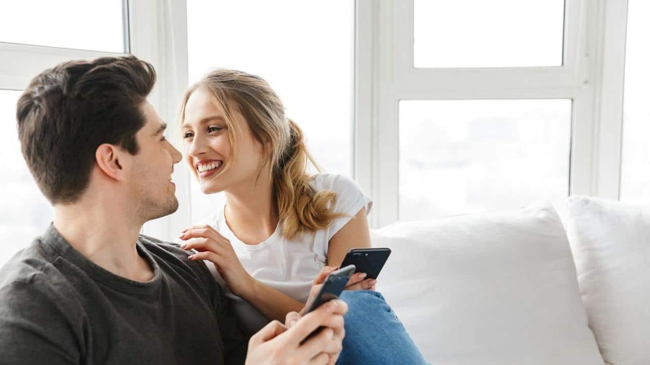 Happy man and woman looking in each other's eyes and smiling.