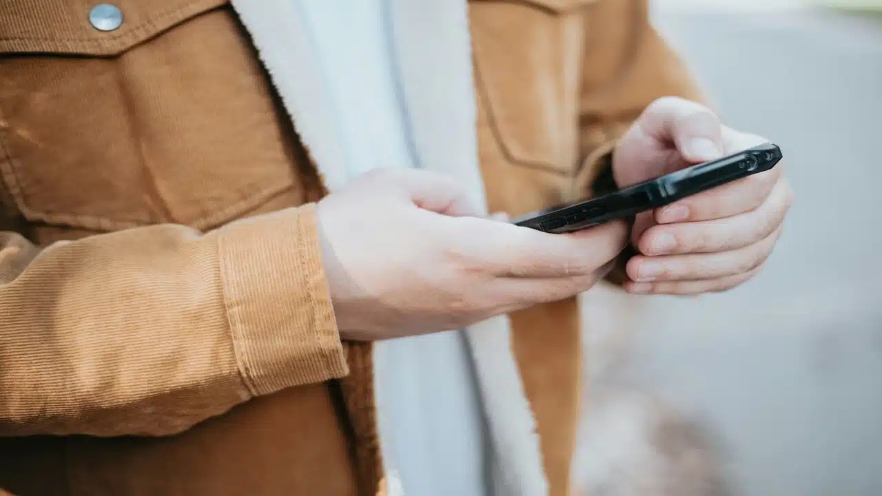 A man texting outdoors