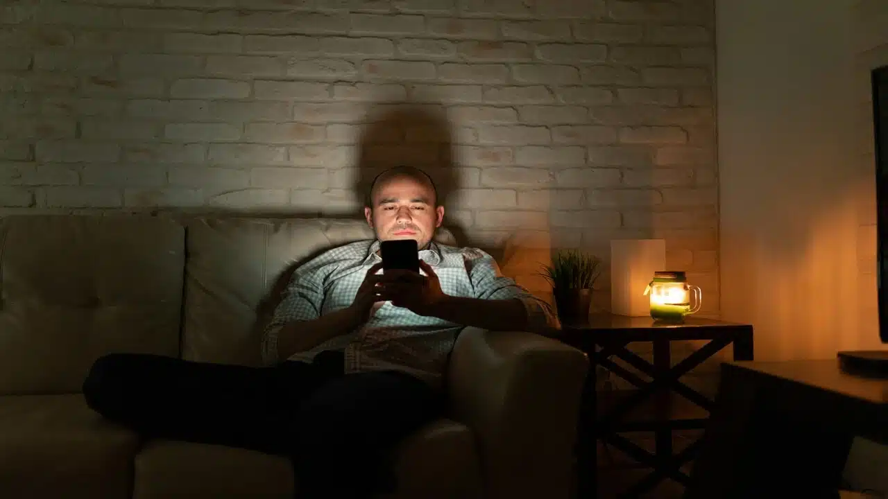 A man texting at night