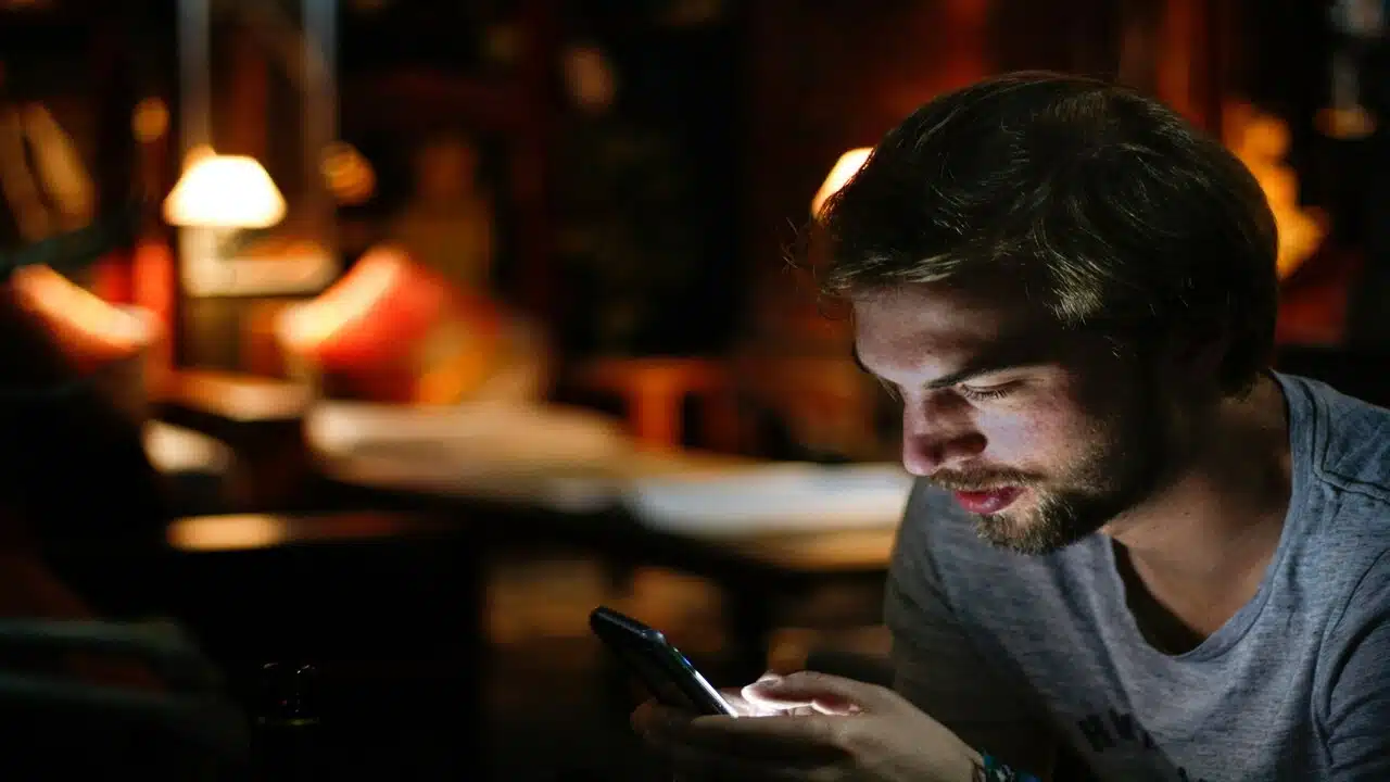 A man using his phone at night