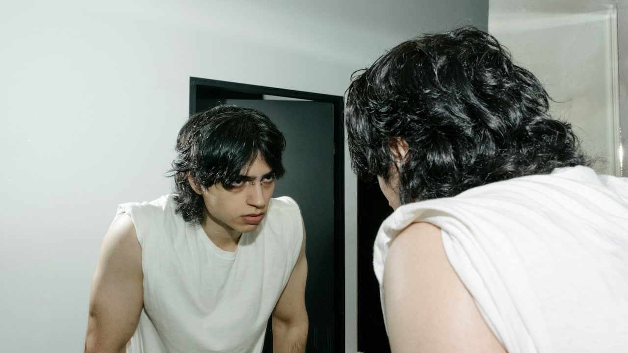 An angry man looking at himself in the mirror.