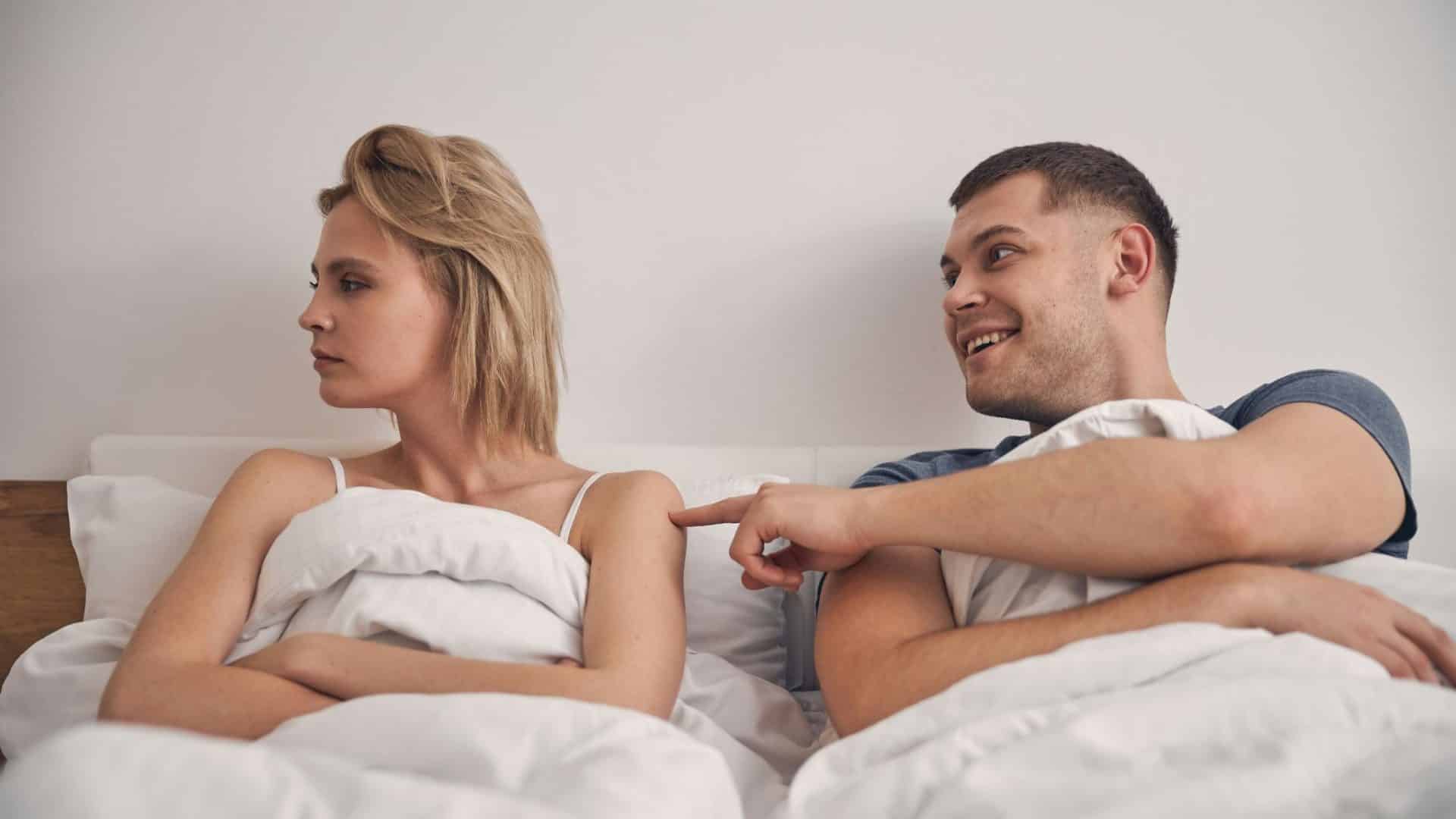 A man poking woman’s shoulder