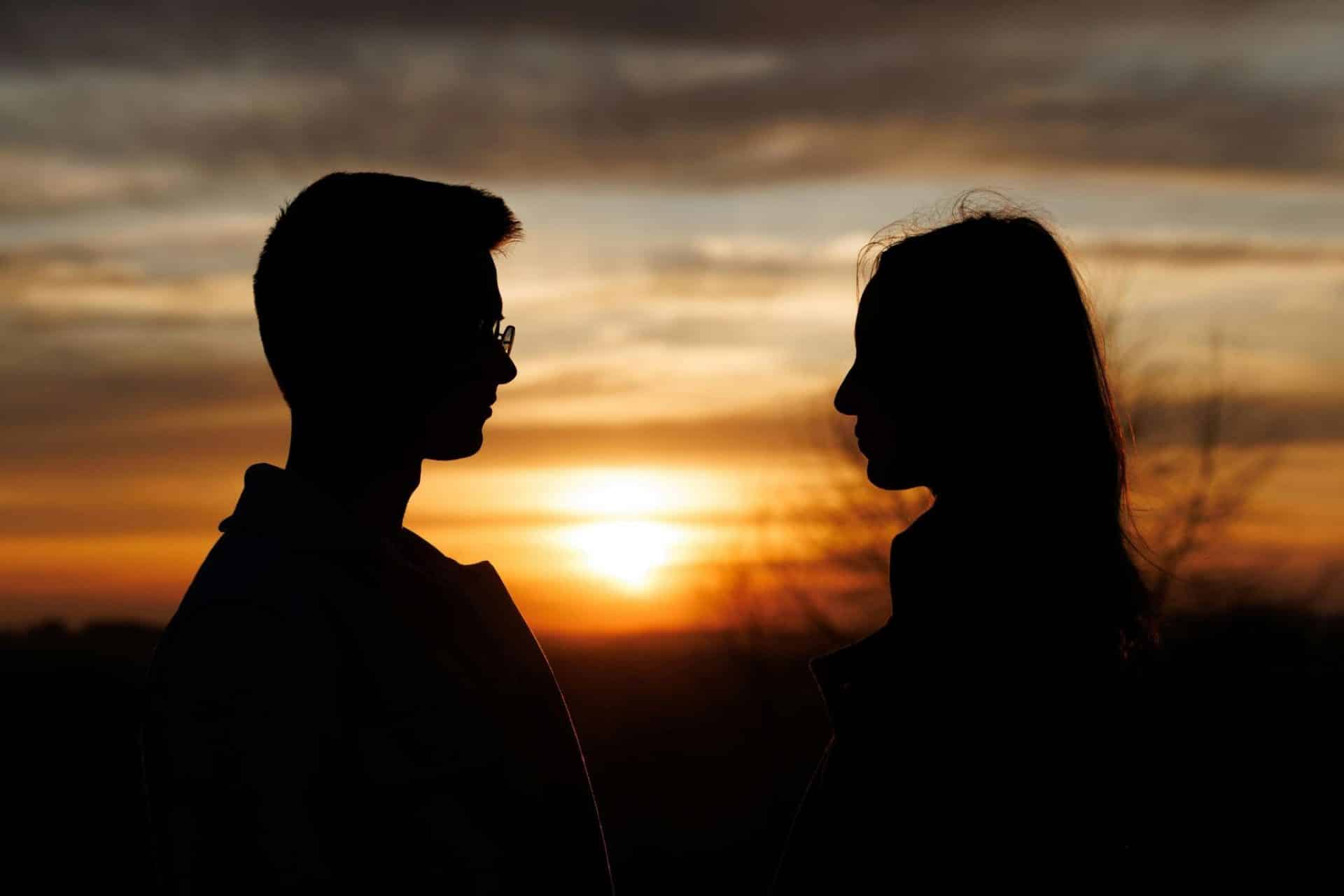 A couple apart at sunset.