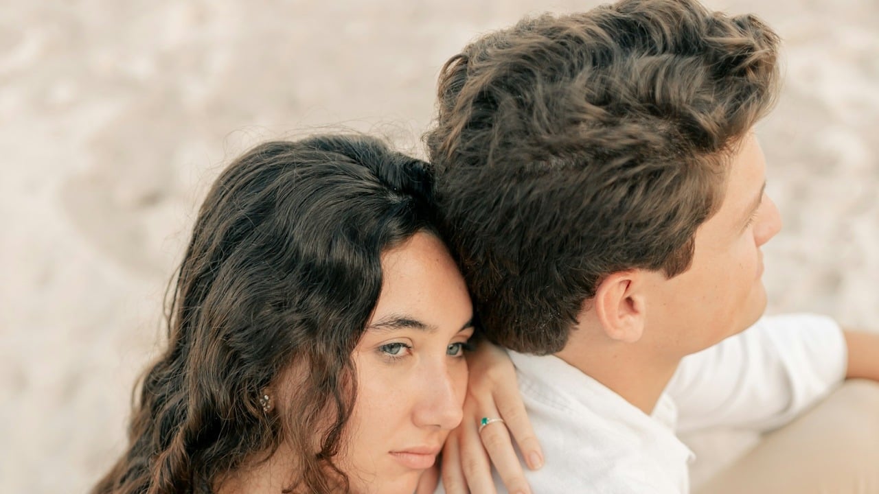 A couple sitting on a beach.