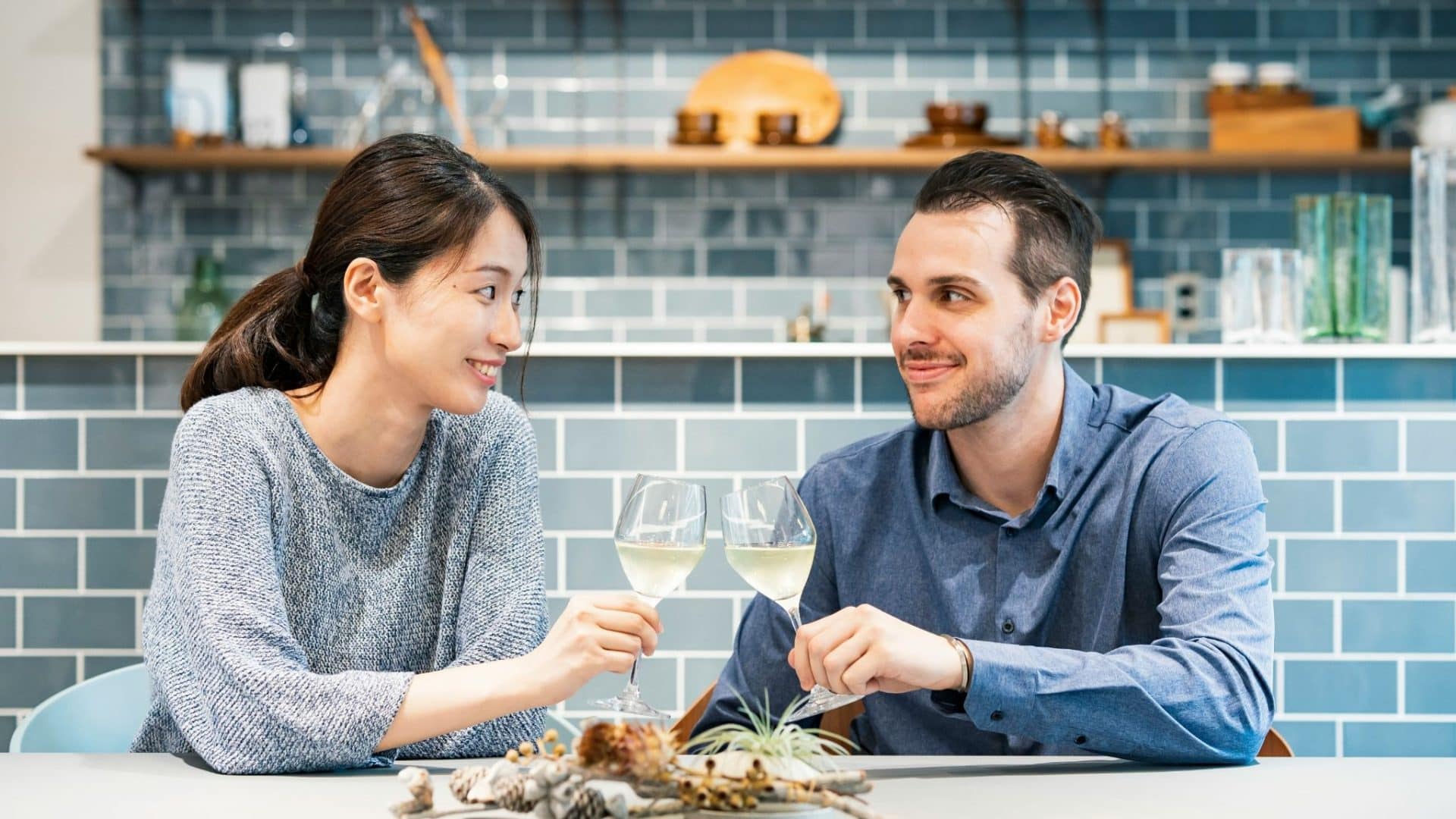 A man smiling awkwardly to woman