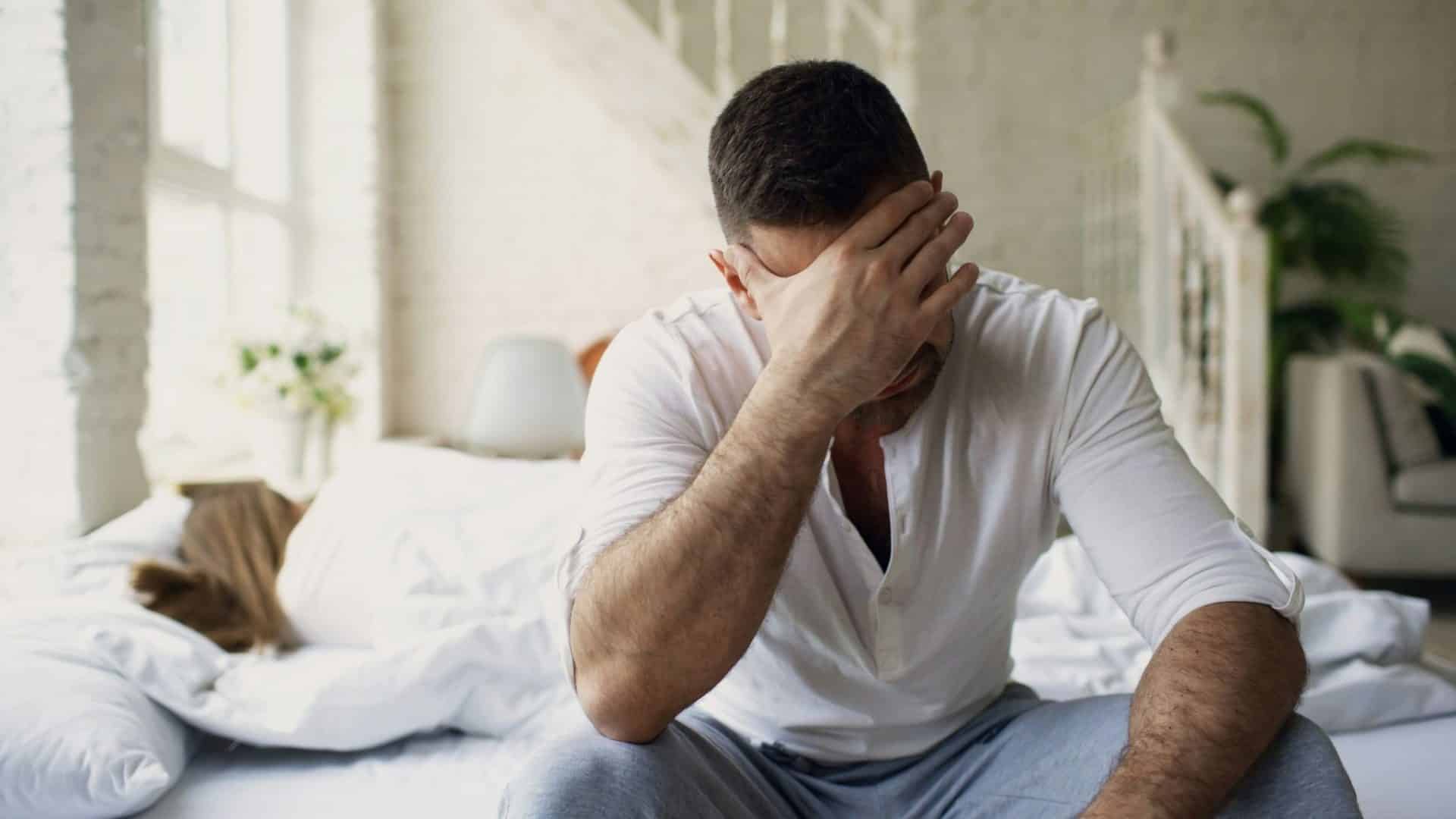 A man holding his head