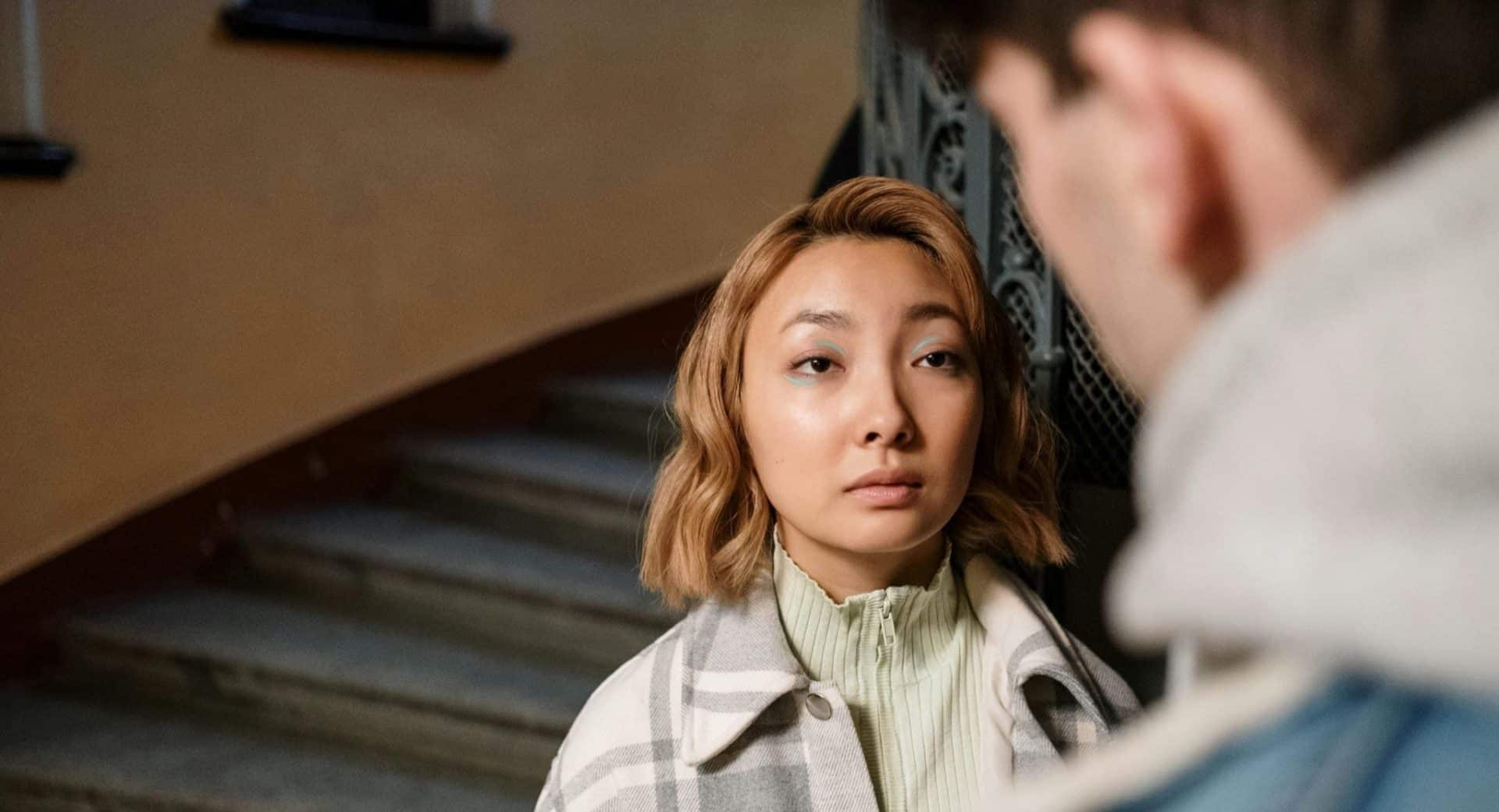 A woman looking uneasy after expressing a concern.