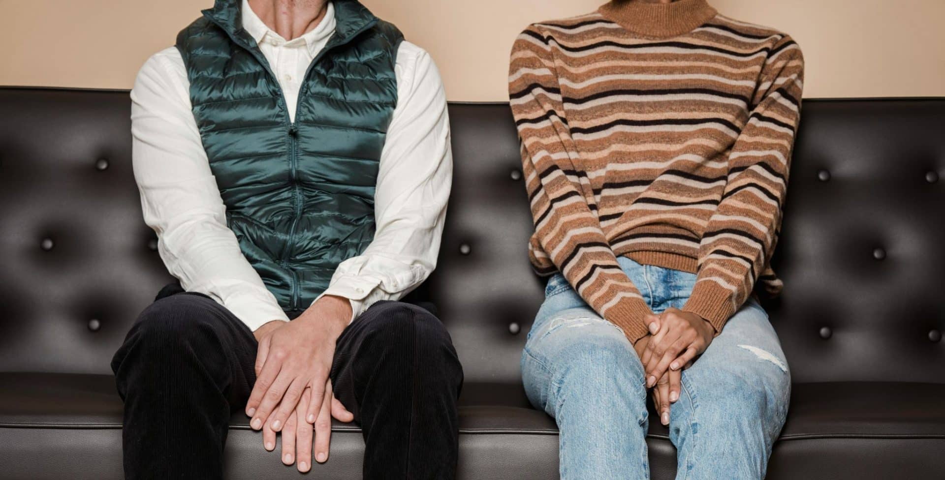 A couple sitting together but not fully at ease.