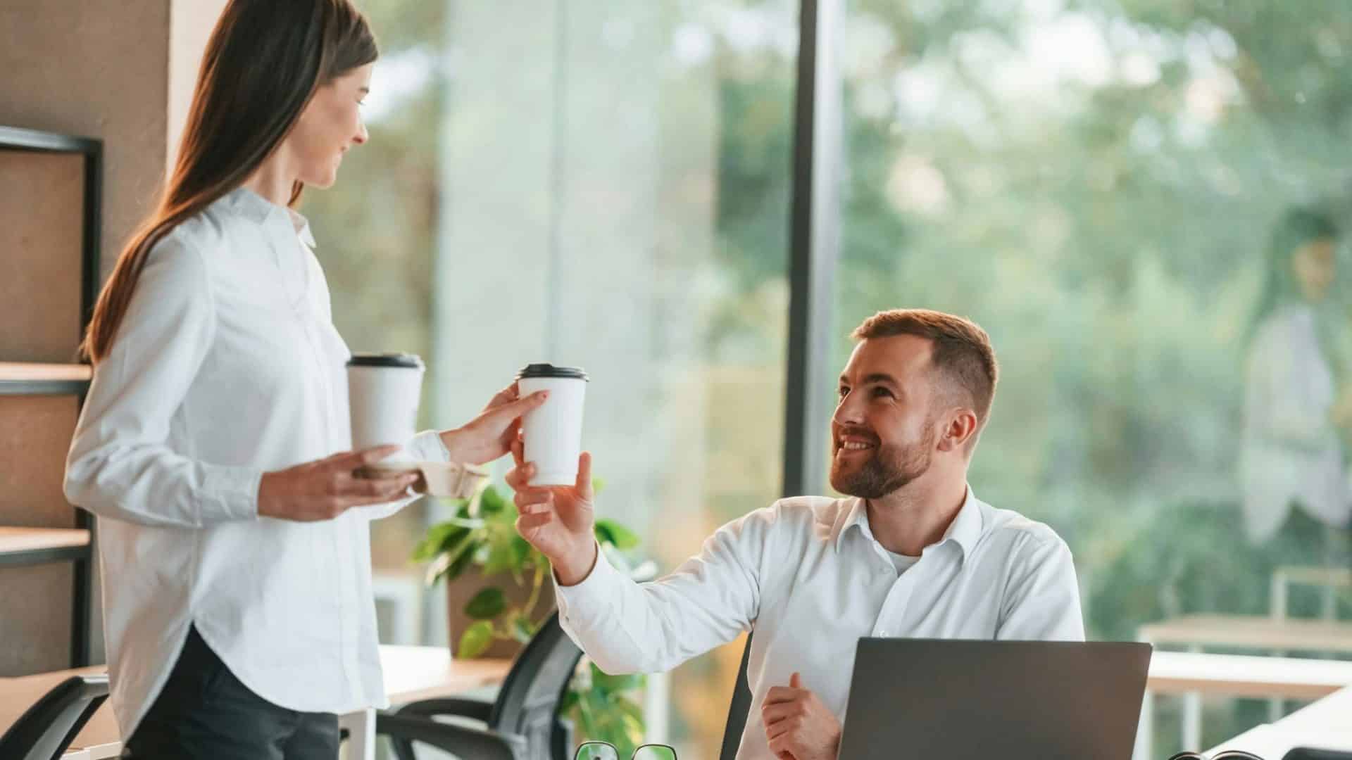 Woman giving coffee to woman