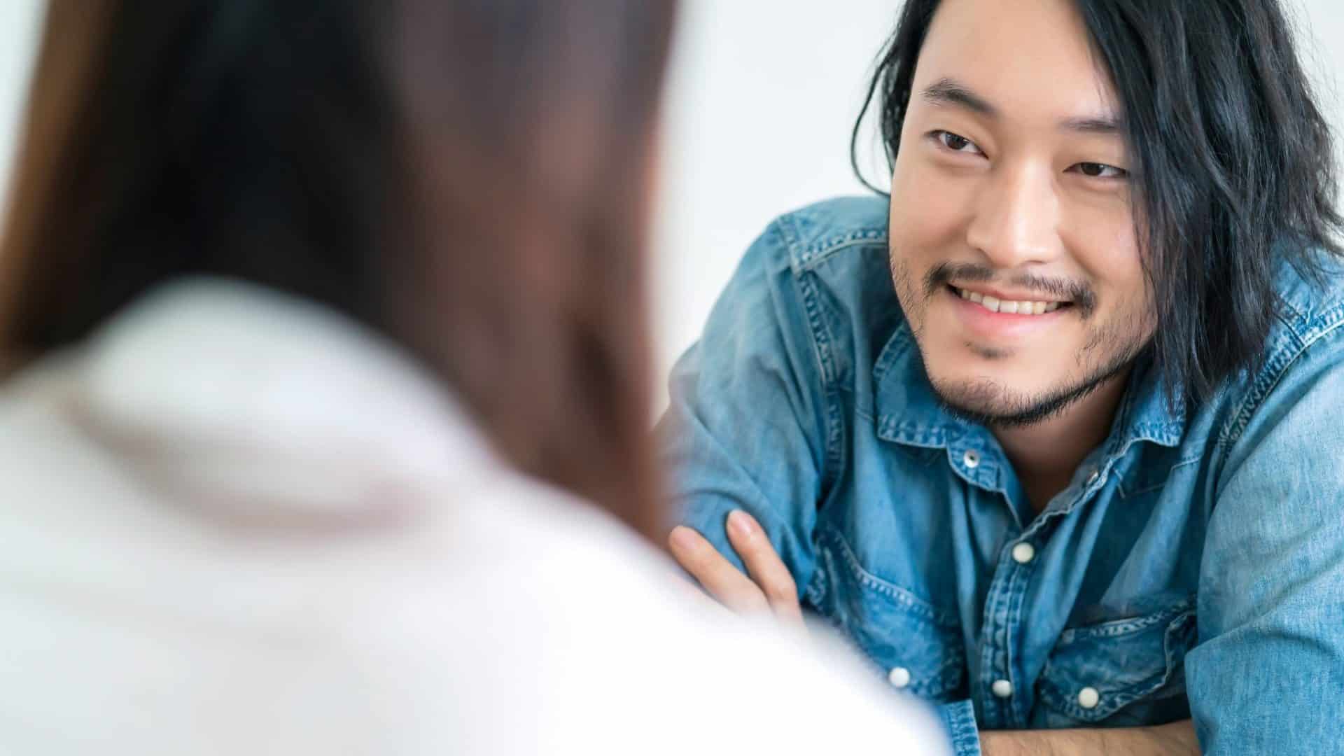 A man smiling to a woman