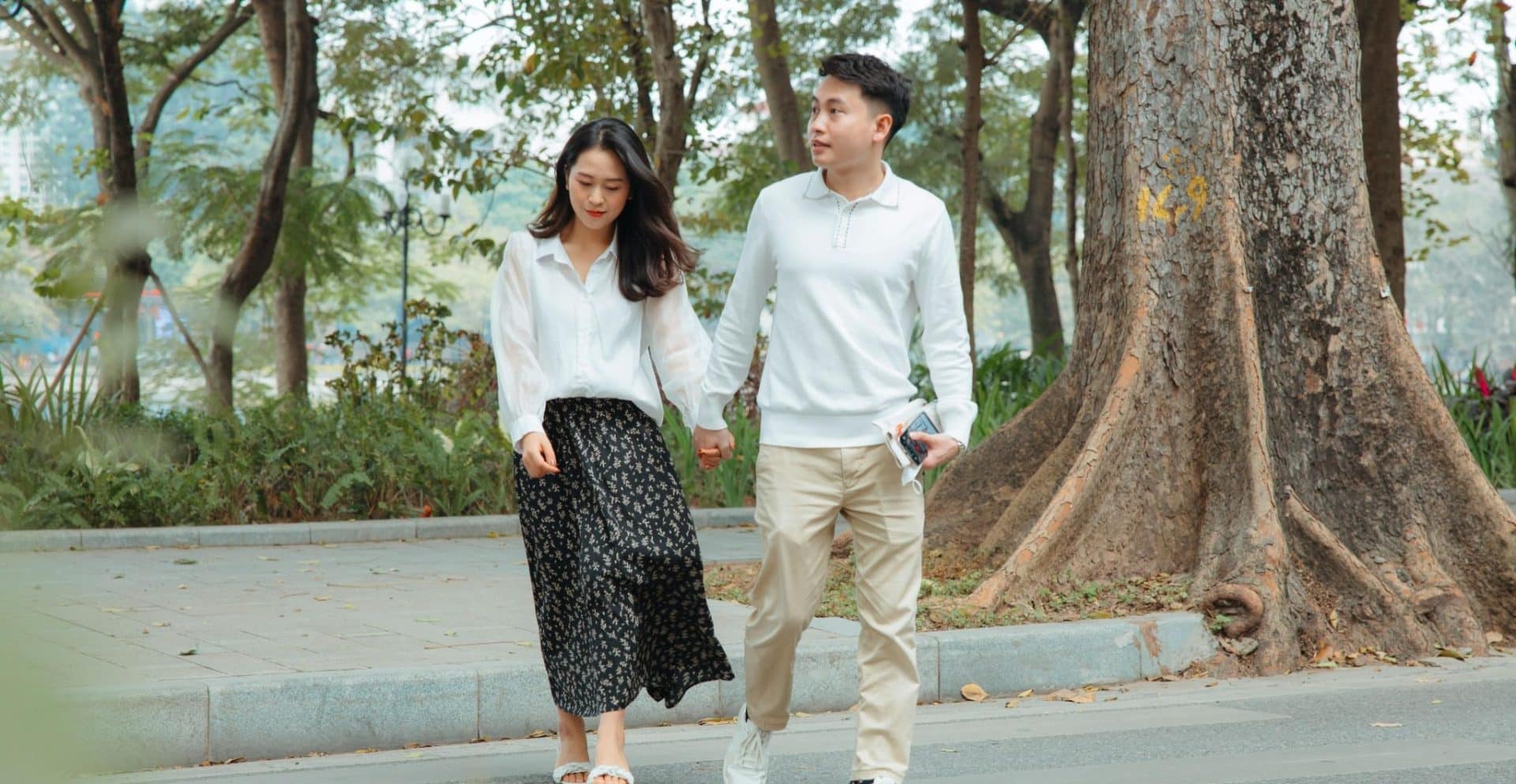 A couple holding hands during a walk.