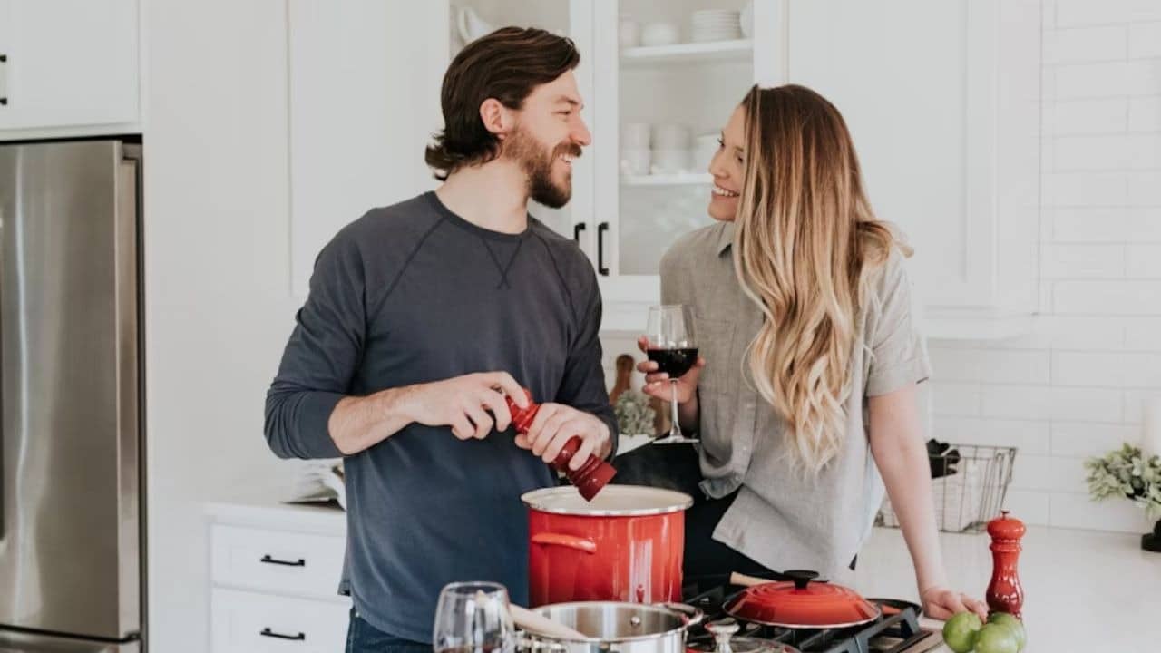 A couple cooking a meal together in a modern kitchen